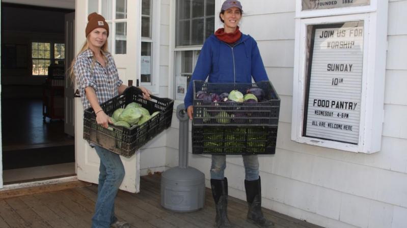 Melissa Mapes, left, and Jess Tonn of Share the Harvest Farm drop off vegetables at the Springs Food Pantry. 