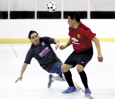 Eddy Sacaquirin, right, of Liga del Milagro headed a ball while Hugo Villacis of the East Hampton Soccer Stars applied defensive pressure in recent over-37 league action at the Sportime Arena in Amagansett. Eddy Sacaquirin, right, of Liga del Milagro headed a ball while Hugo Villacis of the East Hampton Soccer Stars applied defensive pressure in recent over-37 league action at the Sportime Arena in Amagansett.