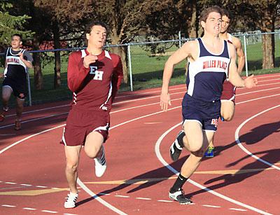 Chris Reich, who coaches the East Hampton High School boys track team, was happy to have Hunter Kelsey, at left, on his way to winning the 200 in the Miller Place meet, back in action.