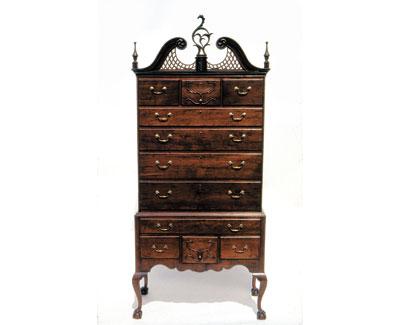 A New England tall chest augmented to increase its value. A New England tall chest augmented to increase its value.