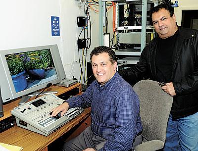 The Schimizzi brothers — Ernie, sitting, with Greg standing behind him — are celebrating 20 years of television in East Hampton. The Schimizzi brothers — Ernie, sitting, with Greg standing behind him — are celebrating 20 years of television in East Hampton.