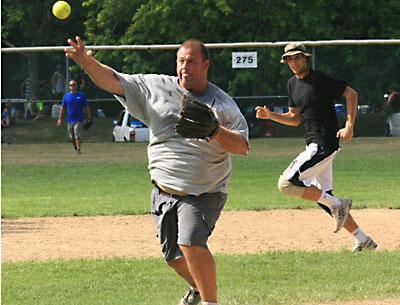 Geoff Miller, though he’s added some pounds since he played the hot corner for Fred’s Big Guns, four-time men’s slow-pitch champions in the 1990s, pitched and fielded well for the Springs Fire Department’s entry. Geoff Miller, though he’s added some pounds since he played the hot corner for Fred’s Big Guns, four-time men’s slow-pitch champions in the 1990s, pitched and fielded well for the Springs Fire Department’s entry.