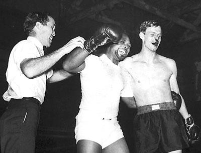 Nose bloodied and eyes watering, George Plimpton was nonetheless triumphant, in his way, after a stint in the ring with Archie Moore. Nose bloodied and eyes watering, George Plimpton was nonetheless triumphant, in his way, after a stint in the ring with Archie Moore.