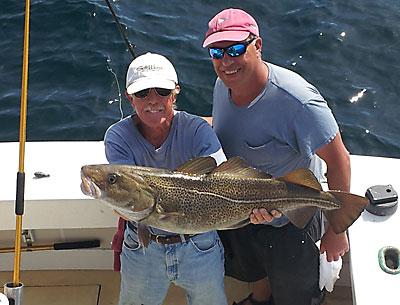Butch Maher, left, first mate on the charter boat Blue Fin IV, showed off the 25-pound cod caught by the angler Robert Macbarb of East Hampton on Sunday.