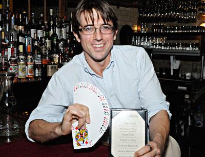 Michael Dollar, the bartender/magician at the Vine Street Cafe on Shelter Island, performs card tricks for well-behaved patrons. He also reads auras and has concocted his own specialty drinks menu.
