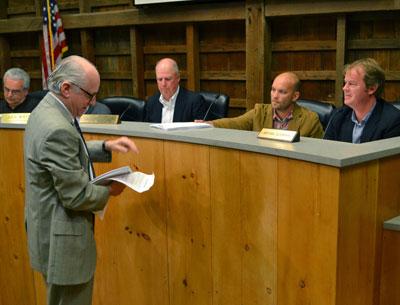 David Lys, the  newest member of the East Hampton Town Zoning Board of Appeals was handed documents by Jeffrey Bragman during his first public hearing. From left were Don Cirillo, Mr. Bragman, Alex Walter, the board’s chairman, Mr. Lys, and Bryan Gosman.
