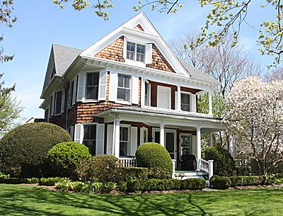 This Southampton Victorian-era house has some classic Queen Anne-style features on its exterior, including a front porch and a second-floor porch, prominent gables, an asymmetrical form, and bay windows.