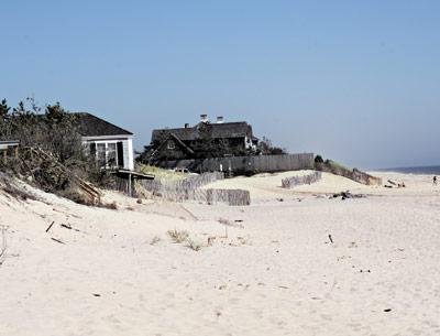 The East Hampton Village Zoning Board of Appeals is considering Molly Zweig’s request to build a sand-covered rock revetment at the edge of her Georgica Beach property, to the left in the above picture.