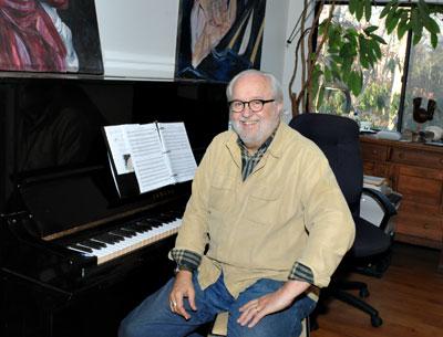 Roger Ames makes music at a piano, electronic keyboard, and laptop at his house in Springs.