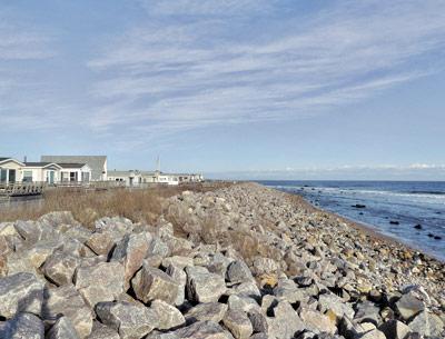 A stone sea wall at the Montauk Shores Condominium in Montauk will be reduced in size and planted with beach grass as part of an agreement between the property association and New York State. A stone sea wall at the Montauk Shores Condominium in Montauk will be reduced in size and planted with beach grass as part of an agreement between the property association and New York State.