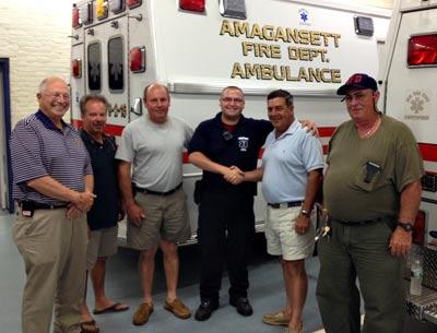 Nick Calace, third from right, a paid paramedic with the Amagansett Fire Department ambulance company, has been recognized for the care he gave a patient having a heart attack on July 9. He posed for a photograph with the fire district commissioners, from left, Jack Emptage, J. Kent Howie, William Vorpahl Jr., Daniel R. Shields II, and Carl Hamilton. Nick Calace, third from right, a paid paramedic with the Amagansett Fire Department ambulance company, has been recognized for the care he gave a patient having a heart attack on July 9. He posed for a photograph with the fire district commissioners, from left, Jack Emptage, J. Kent Howie, William Vorpahl Jr., Daniel R. Shields II, and Carl Hamilton.