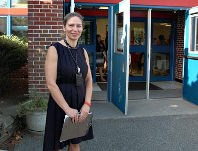 Beth Doyle, the principal of the John M. Marshall Elementary School, greeted students on the first day of classes yesterday morning.