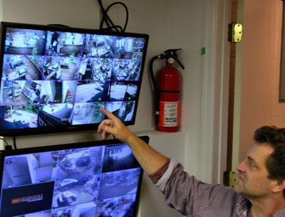 Bruce Damark, a third-generation owner of Damark’s, with monitors for the new surveillance system he put in place to protect the deli. Bruce Damark, a third-generation owner of Damark’s, with monitors for the new surveillance system he put in place to protect the deli.