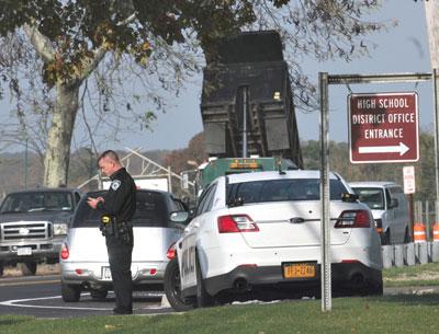 East Hampton High School was evacuated yesterday morning after a threatening message was found written on a bathroom mirror. East Hampton High School was evacuated yesterday morning after a threatening message was found written on a bathroom mirror.