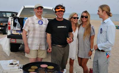 Democratic and Independence Party candidates for East Hampton Town trustee — Zachary Cohen, Rick Drew, and Tyler Armstrong — grilled up hamburgers and veggie burgers with help from Susan and Carly Drew during a beach party at Atlantic Avenue in Amagansett Sunday. Democratic and Independence Party candidates for East Hampton Town trustee — Zachary Cohen, Rick Drew, and Tyler Armstrong — grilled up hamburgers and veggie burgers with help from Susan and Carly Drew during a beach party at Atlantic Avenue in Amagansett Sunday.