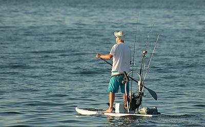 A calm ocean made for ideal conditions as a man on a well-outfitted stand-up paddleboard headed out for some fishing at Atlantic Avenue Beach in Amagansett on Saturday morning.