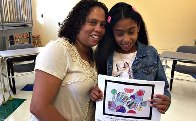 Basilia Garcia, left, and her daughter Yennefer Rodriguez, a seventh grader at the East Hampton Middle School, showed a drawing that earned Yennefer a winning spot in an art competition sponsored by the American Printing House for the Blind.