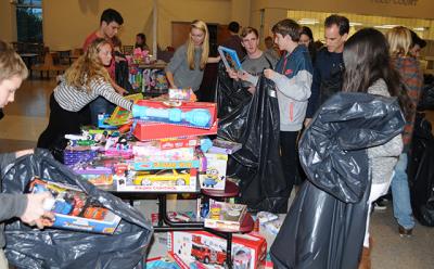 In the East Hampton High School cafeteria on Monday, members of the school’s Key Club sorted some 1,000 toys collected for local children in need by the Kiwanis Club of East Hampton Toys for Tots program.