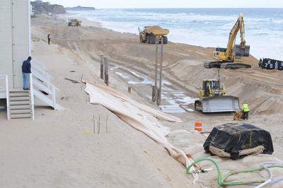 Contractors for the Army Corps of Engineers are moving down the Montauk beach to construct a mostly buried wall of sandbags. The first section, at the western end of the downtown shore, has been completed. Morgan McGivern Contractors for the Army Corps of Engineers are moving down the Montauk beach to construct a mostly buried wall of sandbags. The first section, at the western end of the downtown shore, has been completed. Contractors for the Army Corps of Engineers are moving down the Montauk beach to construct a mostly buried wall of sandbags. The first section, at the western end of the downtown shore, has been completed. Morgan McGivern Contractors for the Army Corps of Engineers are moving down the Montauk beach to construct a mostly buried wall of sandbags. The first section, at the western end of the downtown shore, has been completed.