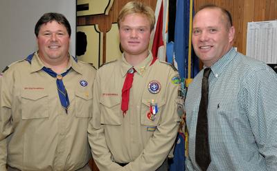 Brenden Snow, center, received his Eagle Scout Award during a ceremony on Sunday attended by many well-wishers including Vincent Franzone, left, who pinned the badge on him, and his father, Scott Snow. Brenden Snow, center, received his Eagle Scout Award during a ceremony on Sunday attended by many well-wishers including Vincent Franzone, left, who pinned the badge on him, and his father, Scott Snow.