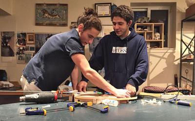 Yanni Giannakopoulos, left, and Malik Basnight, right, have taken on complicated woodworking projects at the Ross School. Yanni is replicating a famous guitar, Malik is building four artistic chairs, and the two friends have been helping each other along the way. Yanni Giannakopoulos, left, and Malik Basnight, right, have taken on complicated woodworking projects at the Ross School. Yanni is replicating a famous guitar, Malik is building four artistic chairs, and the two friends have been helping each other along the way.