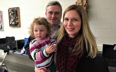Beth Doyle, right, the principal at the John M. Marshall Elementary School, was granted tenure on Tuesday night. There with her were her husband, Michael Guinan, an assistant principal at Pierson High School, and their daughter, Olive. Beth Doyle, right, the principal at the John M. Marshall Elementary School, was granted tenure on Tuesday night. There with her were her husband, Michael Guinan, an assistant principal at Pierson High School, and their daughter, Olive.