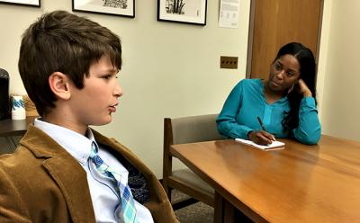 Harry Roussel of Sag Harbor, left, spoke about dyslexia with an aide to New York State Assemblywoman Catherine Nolan, who represents a district in Queens.