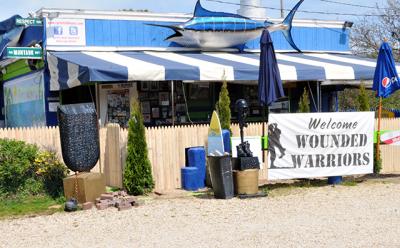 A new stockade fence will prohibit customers at Cyril’s Fish House, the popular roadside bar on Napeague, from spilling out onto the highway, as part of an agreement between owners of the property and the town. A new stockade fence will prohibit customers at Cyril’s Fish House, the popular roadside bar on Napeague, from spilling out onto the highway, as part of an agreement between owners of the property and the town.