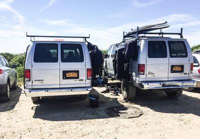 Surfing lesson operators have been criticized for taking too much space at Ditch Plain Beach in Montauk, like these vans used by the Corey's Wave company, and creating havoc in the water, as well as making aggressive sales pitches to passers-by.