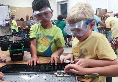 Harry Thomas, left, and Jackson Rogers took apart a broken computer keyboard to see what was inside during an activity called Maker Studio at Camp Invention. Harry Thomas, left, and Jackson Rogers took apart a broken computer keyboard to see what was inside during an activity called Maker Studio at Camp Invention.