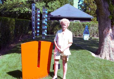 Like much of Carol Ross’s aluminum sculpture, “Gorge,” seen here with the artist in Guild Hall’s sculpture garden, is an abstract, almost Minimalist response to nature. Like much of Carol Ross’s aluminum sculpture, “Gorge,” seen here with the artist in Guild Hall’s sculpture garden, is an abstract, almost Minimalist response to nature.