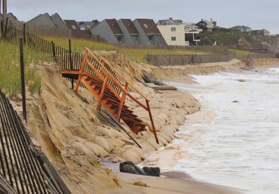 Repairs will be made by the Army Corps after ocean waves last weekend washed away sand, exposing the sandbag seawall installed by the federal agency along the downtown Montauk beach, and leaving a stairway over the dune precariously perched above the surf. Repairs will be made by the Army Corps after ocean waves last weekend washed away sand, exposing the sandbag seawall installed by the federal agency along the downtown Montauk beach, and leaving a stairway over the dune precariously perched above the surf.