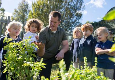 Bryan Smith, center, a Ross School science teacher, often leads lessons outdoors on the Lower School campus, which has recently been certified as a wildlife habitat by the National Wildlife Federation. Bryan Smith, center, a Ross School science teacher, often leads lessons outdoors on the Lower School campus, which has recently been certified as a wildlife habitat by the National Wildlife Federation.