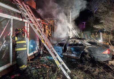 A burned-out shell was all that remained of the Mercedes that crashed through a fence before slamming into a house on Hayground Road in Water Mill early Sunday morning. The house was badly damaged by fire. A burned-out shell was all that remained of the Mercedes that crashed through a fence before slamming into a house on Hayground Road in Water Mill early Sunday morning. The house was badly damaged by fire.