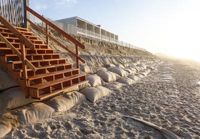 The sandbag wall on Montauk’s downtown beach will be repaired and covered with sand by contractors for the Army Corps of Engineers one more time. The sandbag wall on Montauk’s downtown beach will be repaired and covered with sand by contractors for the Army Corps of Engineers one more time.
