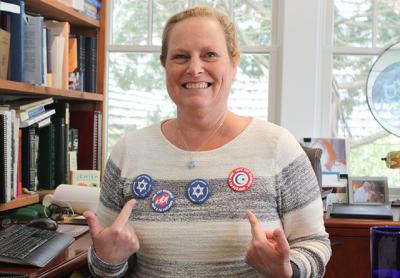Cantor Debra Stein is among the members of East Hampton Clericus distributing buttons bearing the message “Love Thy Neighbor.” Cantor Debra Stein is among the members of East Hampton Clericus distributing buttons bearing the message “Love Thy Neighbor.”