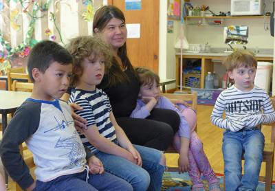 The Country School in Wainscott, founded by Deena Zenger, seen here sitting with students, received an eviction notice from East Hampton Town this week. The Country School in Wainscott, founded by Deena Zenger, seen here sitting with students, received an eviction notice from East Hampton Town this week.