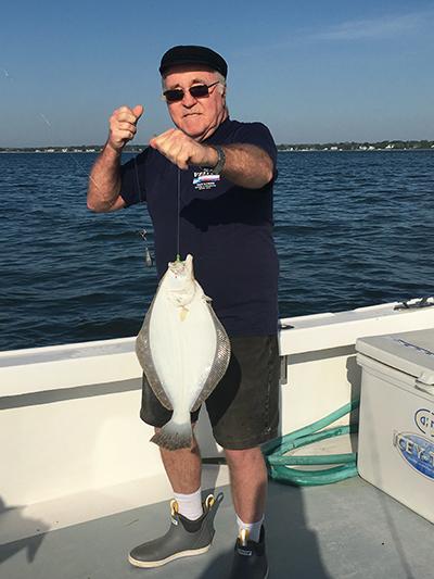 After pulling up a large chowder clam that had clamped onto his hook, Ray Sperling culled a 21-inch keeper fluke in Southold Bay.