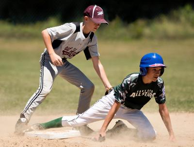 Eli Wolf, the Grey team’s shortstop, put the tag on an East End base runner in the second inning of an 11-to-12-year-old Little League playoff game at the Pantigo Fields. Eli Wolf, the Grey team’s shortstop, put the tag on an East End base runner in the second inning of an 11-to-12-year-old Little League playoff game at the Pantigo Fields.