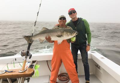 Chad Smith, right, the drummer for the Red Hot Chili Peppers, caught this 41-pound striped bass earlier this month on the Breakaway out of Montauk. With him is the first mate, Eddie Harrison. A picture that ran in this spot last week incorrectly identified the man with a fluke as Mr. Harrison.