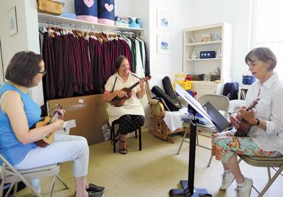 Barbara Raeder, center, with students at her first ukulele class, held at the East Hampton Presbyterian Church on Tuesday. Barbara Raeder, center, with students at her first ukulele class, held at the East Hampton Presbyterian Church on Tuesday.