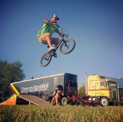 Jeff Mayer caught air at the Hayground School while his son, Luca, looked on. Their 1981 Kenworth semi and its creative-space trailer, is in the background.