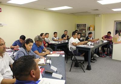 Louise Bergerson’s English as a second language class used mini white boards to practice spelling and writing numbers during the second session of the academic year.