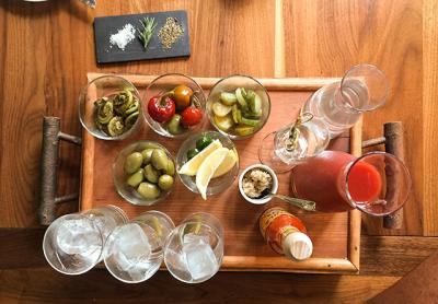 Nick and Toni’s Bloody Mary Board invites patrons to blend their own drinks using various alcohol options, their own mix or straight tomato juice, and a number of garnishes.