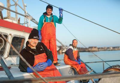 Capt. Bruce Beckwith, in the foreground, with Capt. Charlie Etzel, standing, and First Mate Jeremy Gould — three of the Montauk fishermen who work with Dock to Dish to supply fresh seafood to regional restaurants Capt. Bruce Beckwith, in the foreground, with Capt. Charlie Etzel, standing, and First Mate Jeremy Gould — three of the Montauk fishermen who work with Dock to Dish to supply fresh seafood to regional restaurants