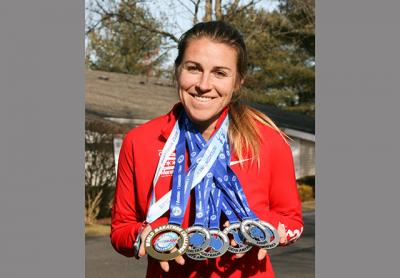 Cara Nelson sports her seven marathon medals won in seven days on seven continents. Cara Nelson sports her seven marathon medals won in seven days on seven continents.