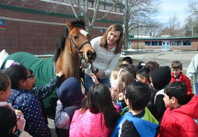 Joanne Jiminez of Hamptons Pony Parties and Jiminez Jumpers brought Annie the pony to meet first graders at the John M. Marshall Elementary School during a lunchtime Brown Bag enrichment event on Friday. Joanne Jiminez of Hamptons Pony Parties and Jiminez Jumpers brought Annie the pony to meet first graders at the John M. Marshall Elementary School during a lunchtime Brown Bag enrichment event on Friday.