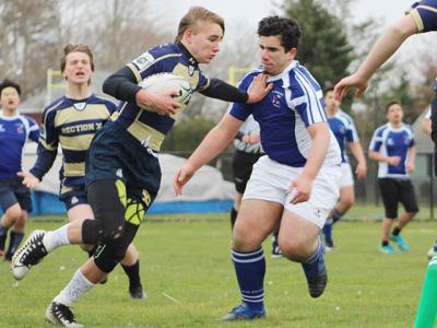 Kevin Bunce Jr., an East Hampton High School freshman, carrying the ball above, and his Rugby Academy teammates are said by Kevin’s father to be well schooled in passing, handling the ball, and tackling.