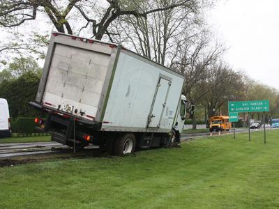 A six-wheeled box truck loaded with cargo got stuck on May 16 when it was driven off the road and onto the steep edge of the village green on East Hampton’s Main Street. Village Police Detective Sgt. Greg Brown said heavy rain played a role in the mishap. Police called Rapid Recovery to tie down the truck and winch it off the dirt so that it did not tip over. No tickets were issued. A six-wheeled box truck loaded with cargo got stuck on May 16 when it was driven off the road and onto the steep edge of the village green on East Hampton’s Main Street. Village Police Detective Sgt. Greg Brown said heavy rain played a role in the mishap. Police called Rapid Recovery to tie down the truck and winch it off the dirt so that it did not tip over. No tickets were issued.