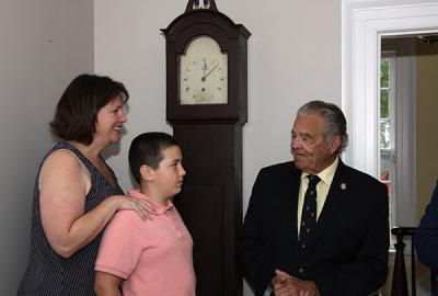 Standing in front of the Dominy clock that they donated to East Hampton Village, Maureen McFall Cayer and her son, David, met with Mayor Paul F. Rickenbach Jr. in the office of Robert Hefner, the village’s director of historic services, last Thursday. Standing in front of the Dominy clock that they donated to East Hampton Village, Maureen McFall Cayer and her son, David, met with Mayor Paul F. Rickenbach Jr. in the office of Robert Hefner, the village’s director of historic services, last Thursday.